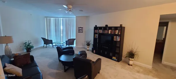 a living room with furniture and a potted plant