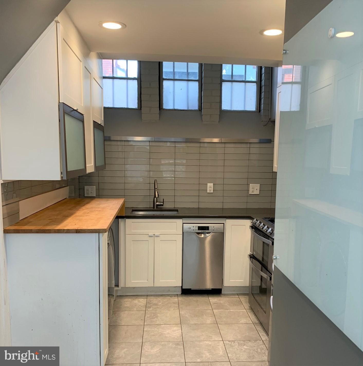 2018 Waverly Street Philadelphia, PA 19146 - Photo 2 of 22 a kitchen with a sink stove and cabinets