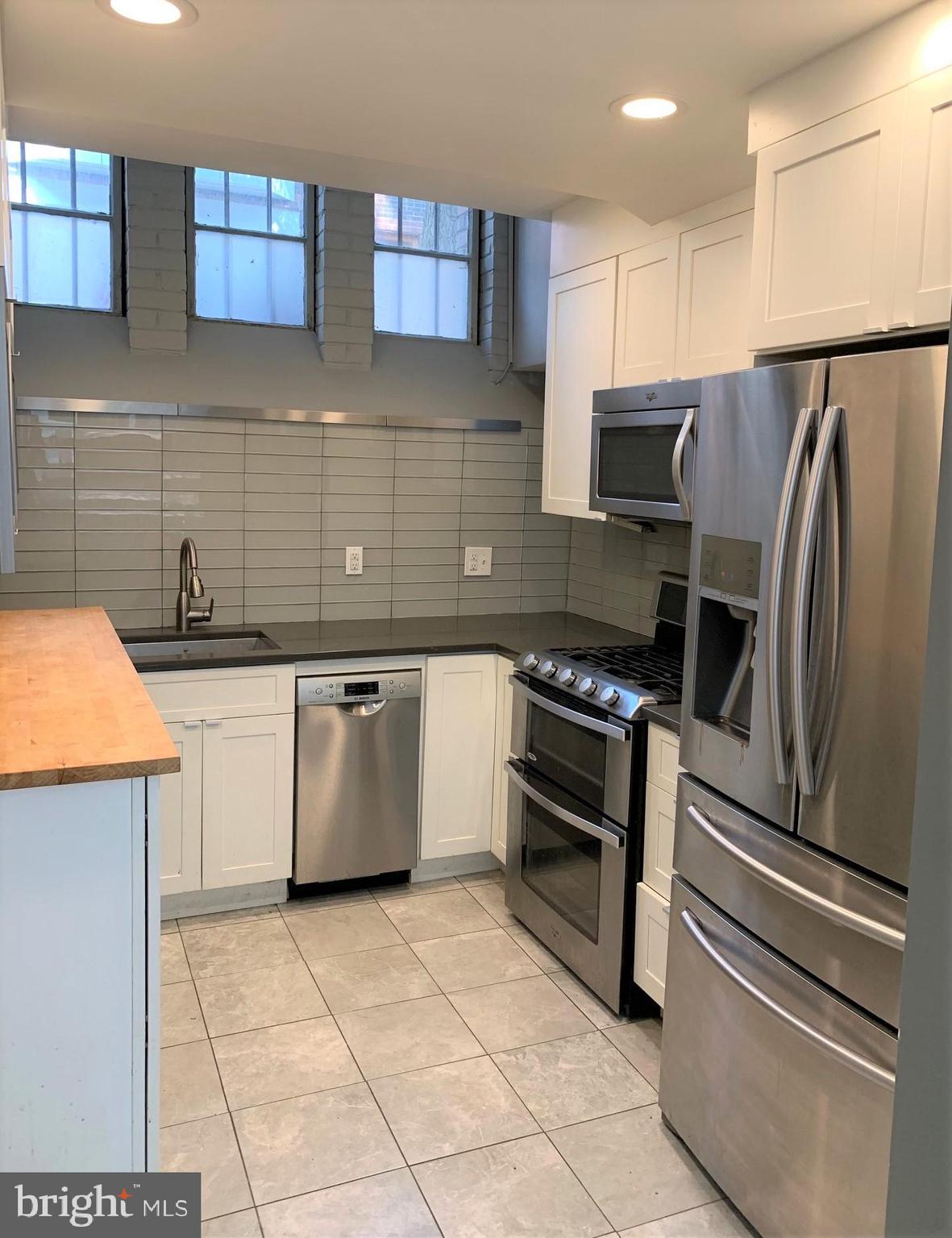 2018 Waverly Street Philadelphia, PA 19146 - Photo 3 of 22 a kitchen with a stove a sink and a refrigerator