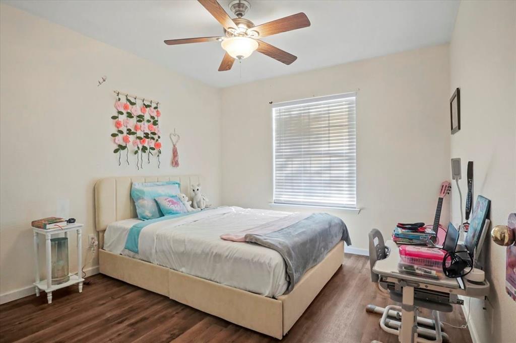 1412 Cheyenne Road Wylie, TX 75098 - Photo 15 of 24 a bedroom with a bed and a chandelier