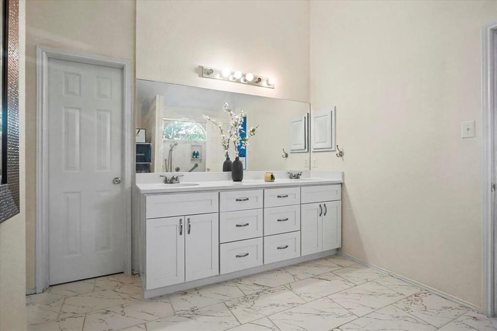 1412 Cheyenne Road Wylie, TX 75098 - Photo 20 of 24 a bathroom with a granite countertop sink a mirror and a