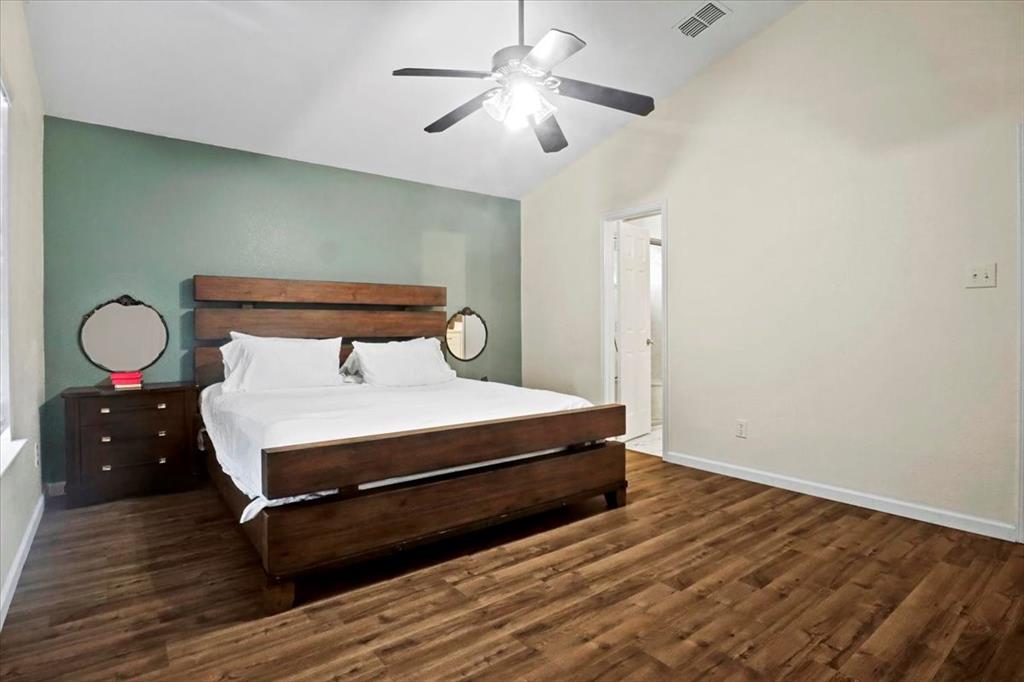 1412 Cheyenne Road Wylie, TX 75098 - Photo 22 of 24 a bedroom with a bed and a chandelier