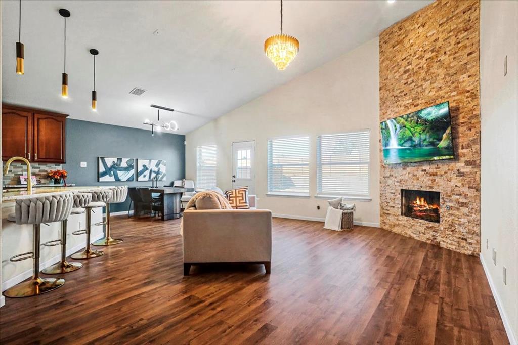 1412 Cheyenne Road Wylie, TX 75098 - Photo 4 of 24 a living room with furniture a fireplace and a floor to ceiling window