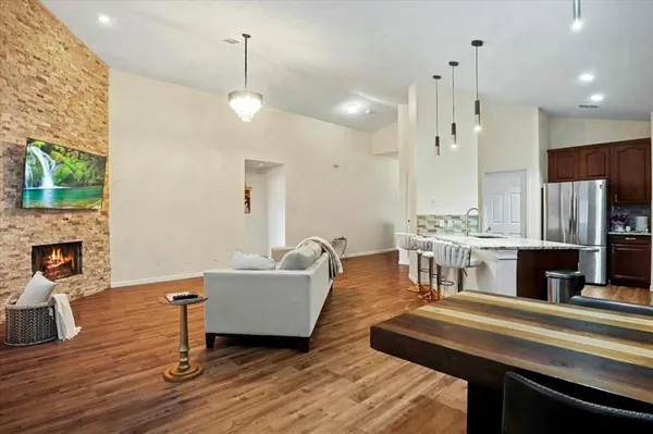 a living room with fireplace furniture and a chandelier