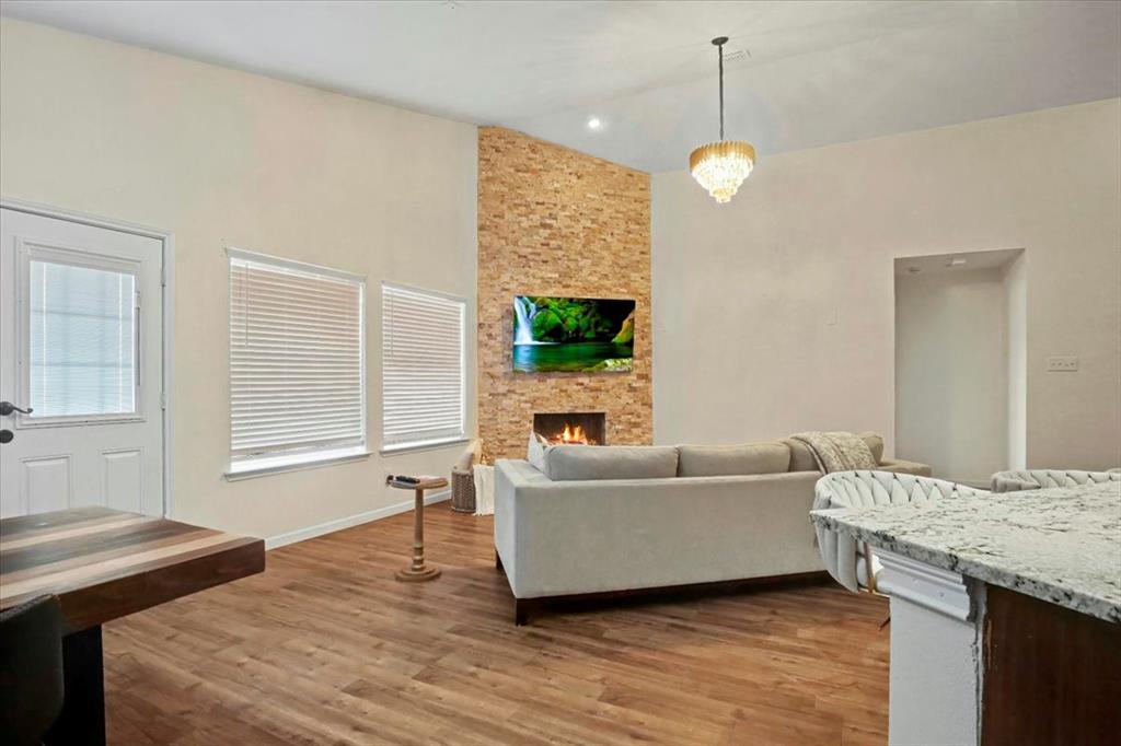 1412 Cheyenne Road Wylie, TX 75098 - Photo 9 of 24 a living room with a couch and a chandelier