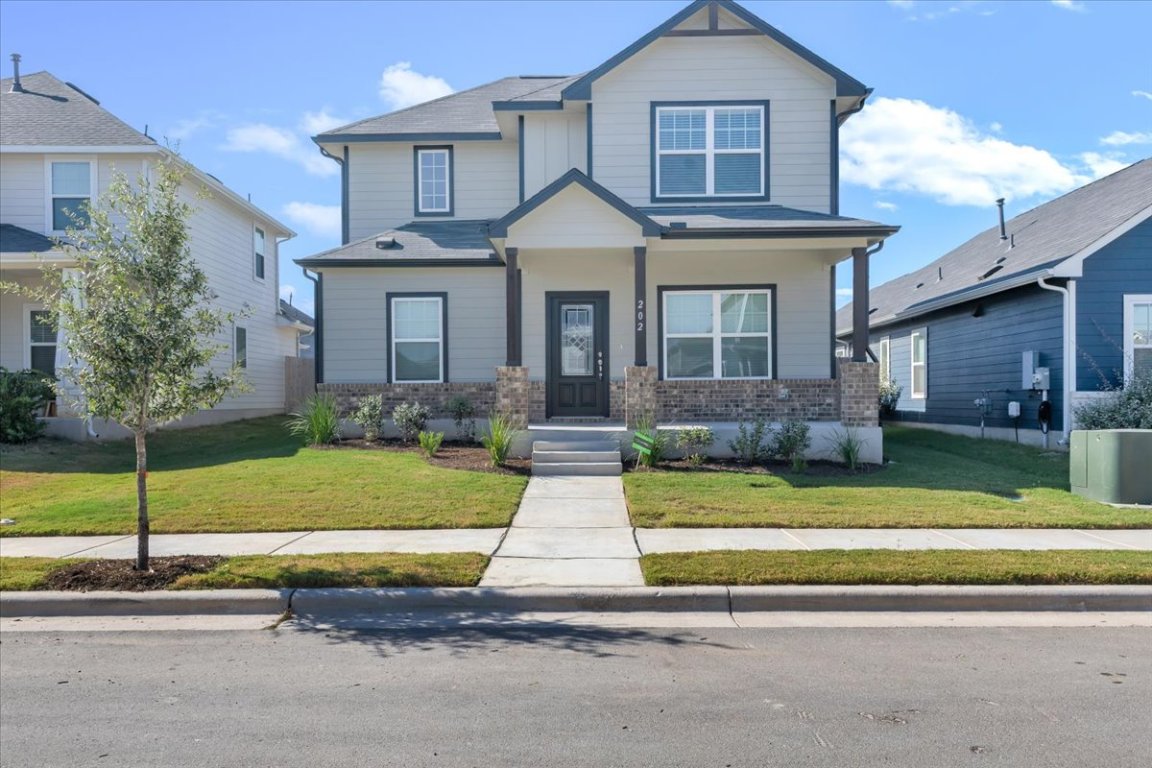 a front view of a house with a yard and porch