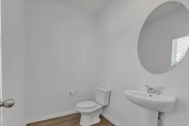 a bathroom with a sink toilet and a mirror