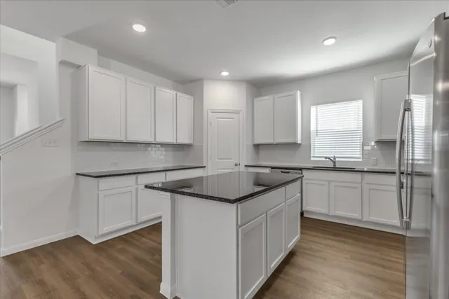 a kitchen with a sink stove and cabinets