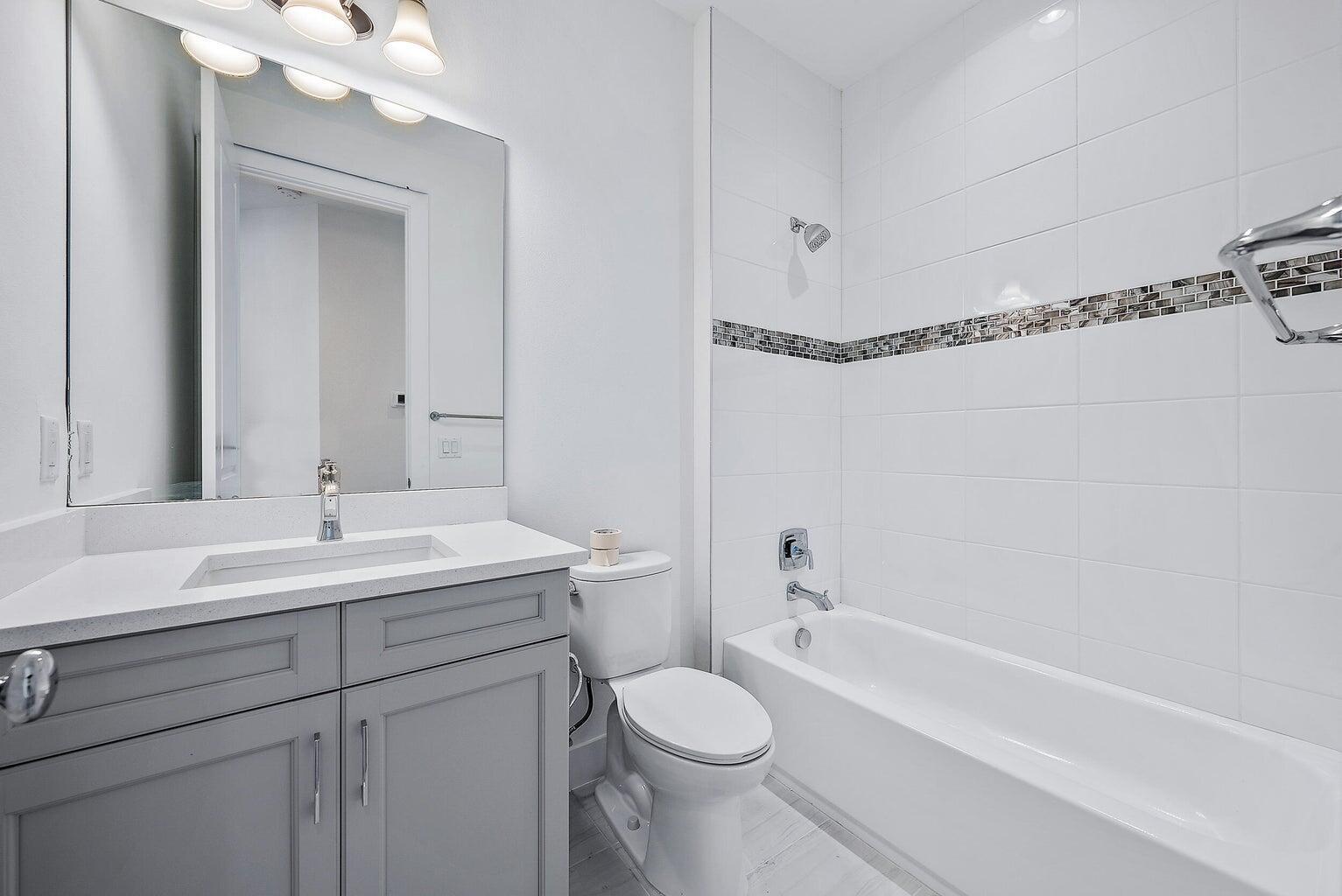 5264 Beckman Terrace Palm Beach Gardens, FL 33418 - Photo 11 of 12 a bathroom with a sink a toilet and shower