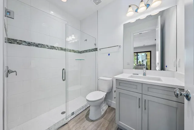 a bathroom with a sink a toilet and shower