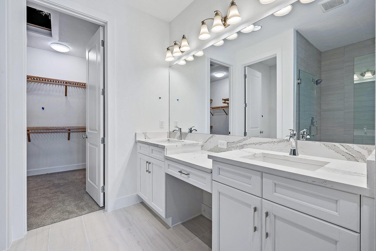 5264 Beckman Terrace Palm Beach Gardens, FL 33418 - Photo 8 of 12 a spacious bathroom with a granite countertop sink a mirror and a shower