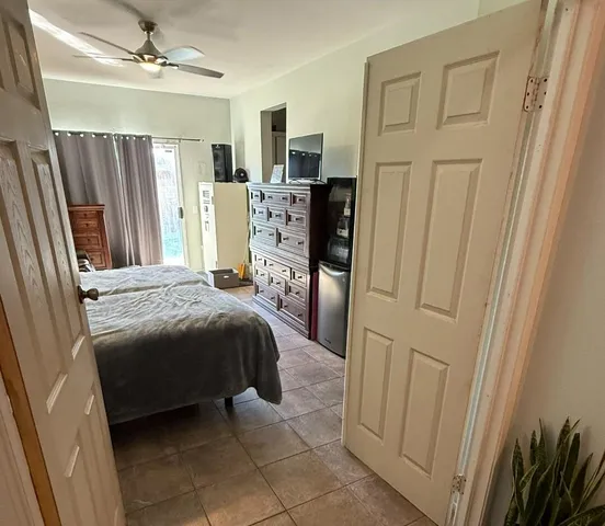 a bedroom with a bed dresser and a window