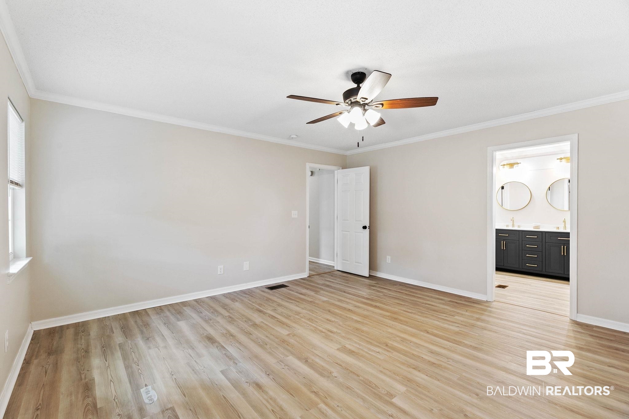 35650 Spring Road North Stapleton, AL 36578 - Photo 35 of 70 Unfurnished bedroom with crown molding, light wood-type flooring, a ceiling fan, and connected bathroom