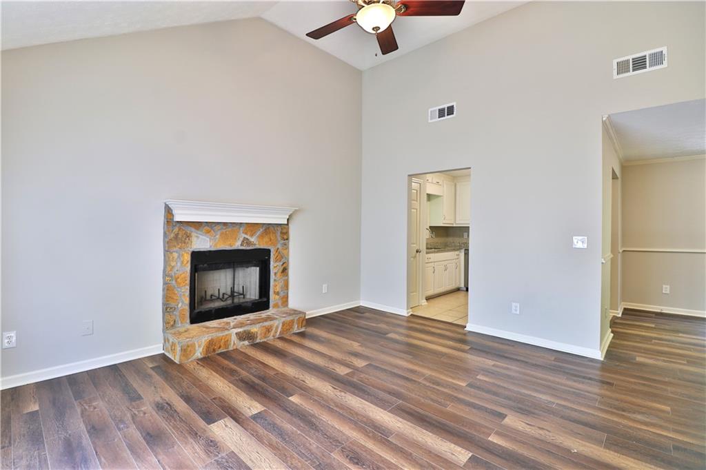 353 Fall View Court Winder, GA 30680 - Photo 23 of 61 a view of an empty room with wooden floor fireplace and a window