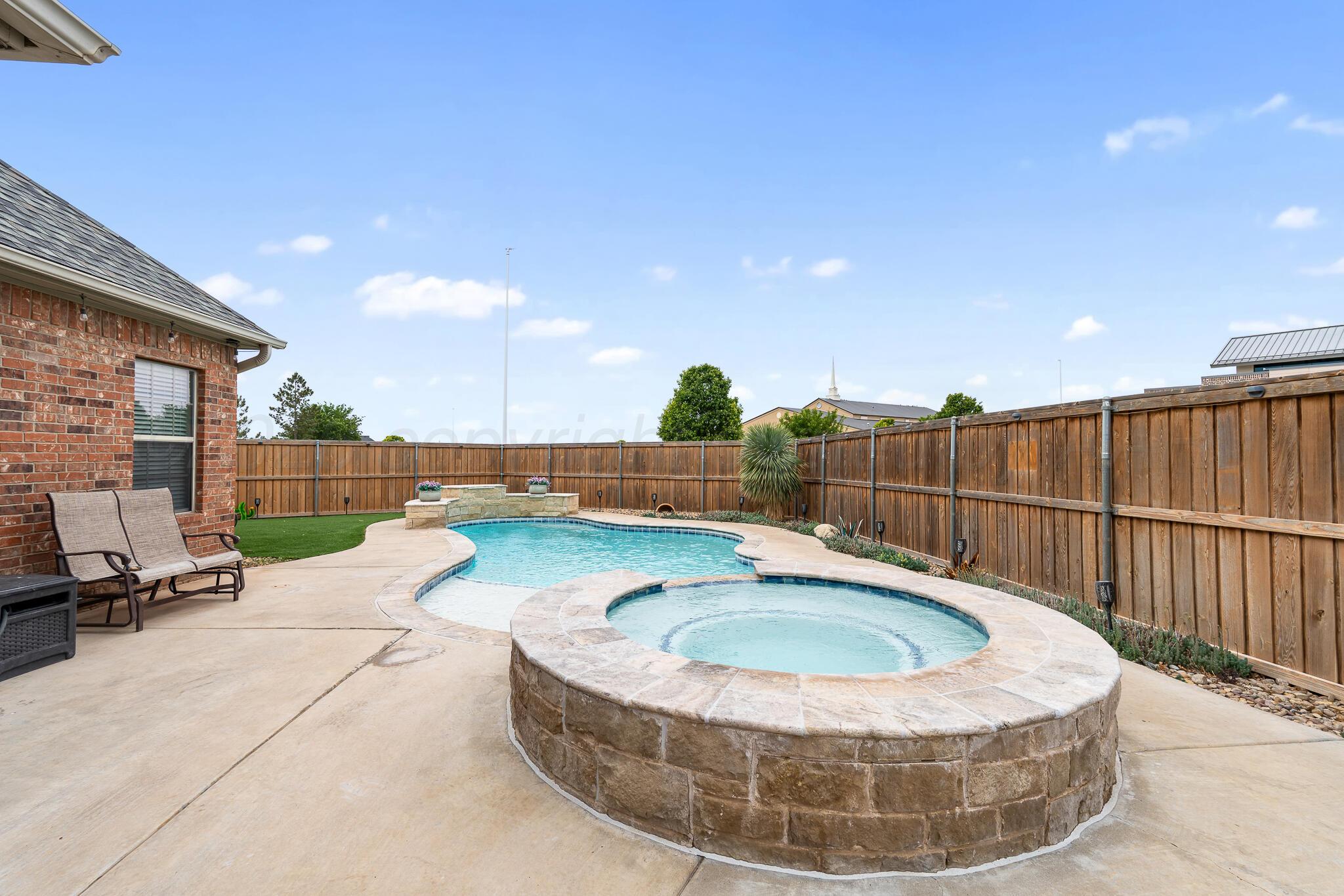 5008 Wesley Road Amarillo, TX 79119 - Photo 41 of 47 a view of a swimming pool with a lounge chair