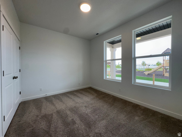 1876 West 1575th North, Unit 237 Layton, UT 84041 - Photo 3 of 20 Unfurnished bedroom featuring a closet and dark carpet