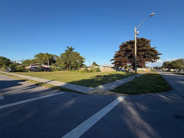 a view of a street with a yard