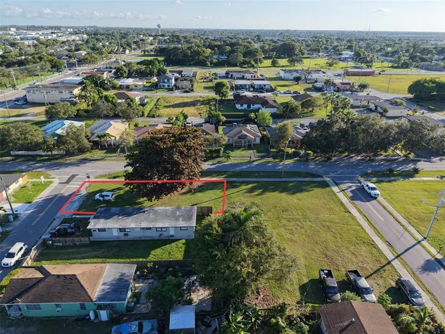 an aerial view of residential houses with outdoor space and swimming pool