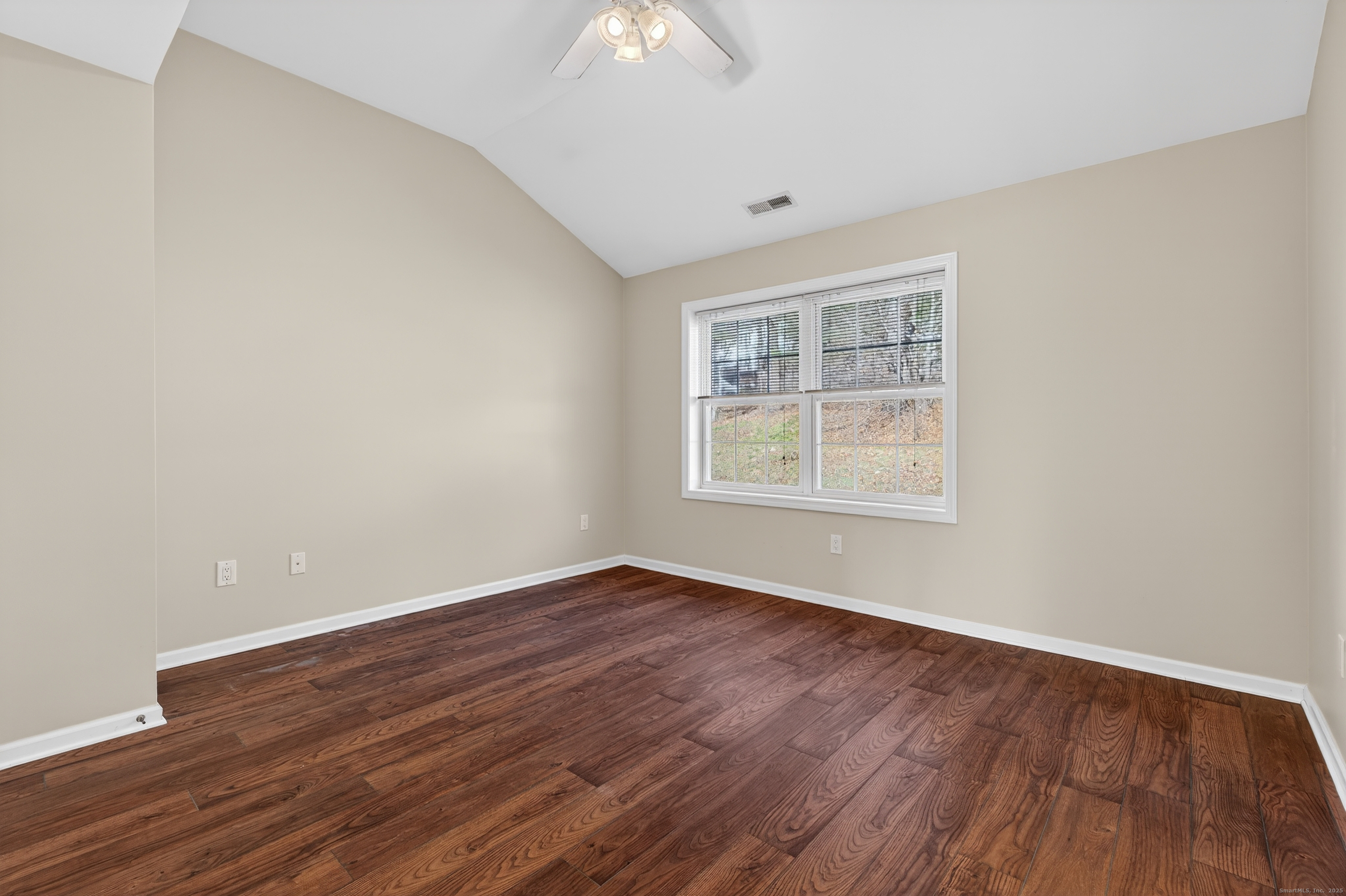 1902 Revere Road, Unit 1902 Danbury, CT 06811 - Photo 12 of 37 an empty room with wooden floor chandelier fan and windows