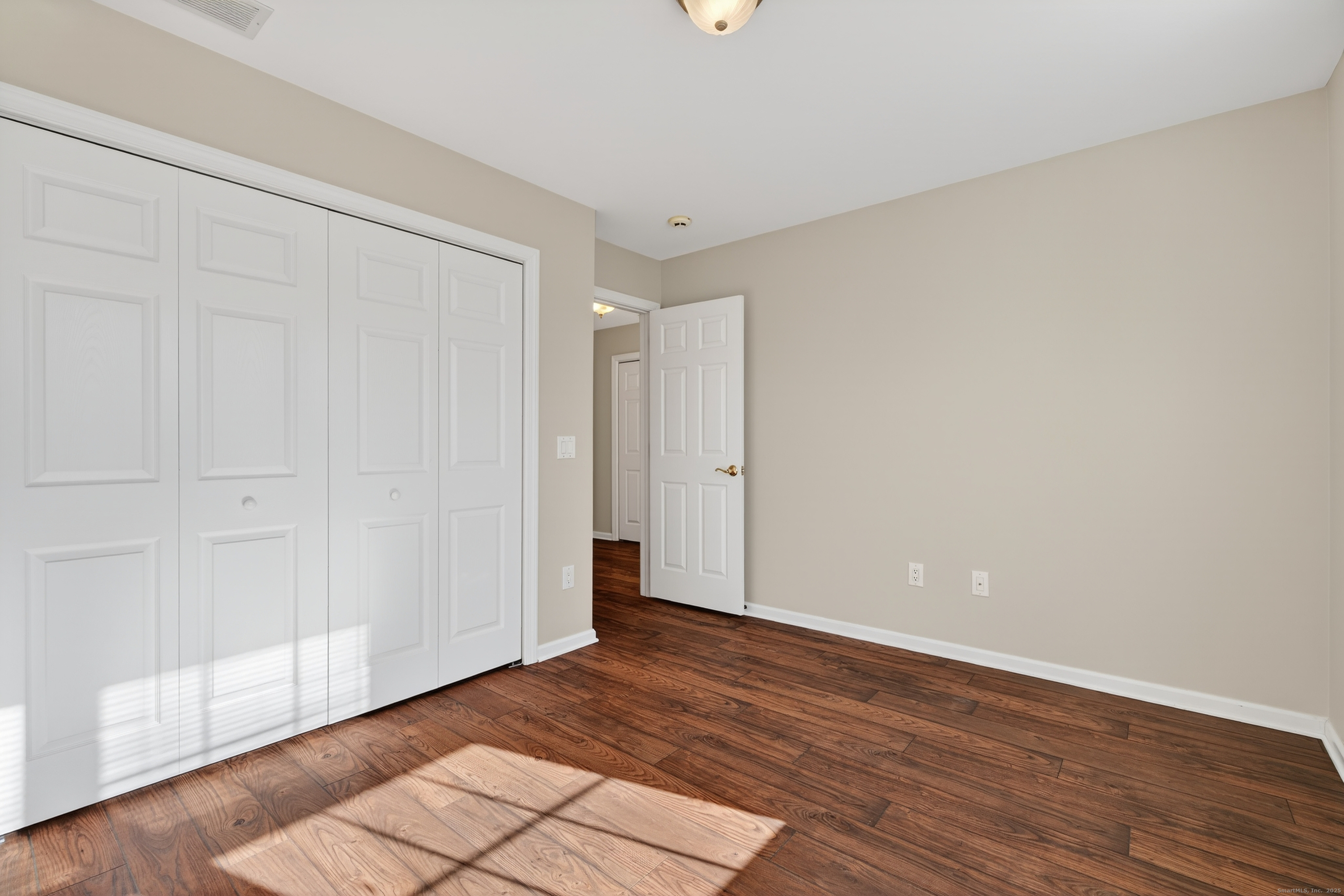 1902 Revere Road, Unit 1902 Danbury, CT 06811 - Photo 16 of 37 a view of an empty room with wooden floor
