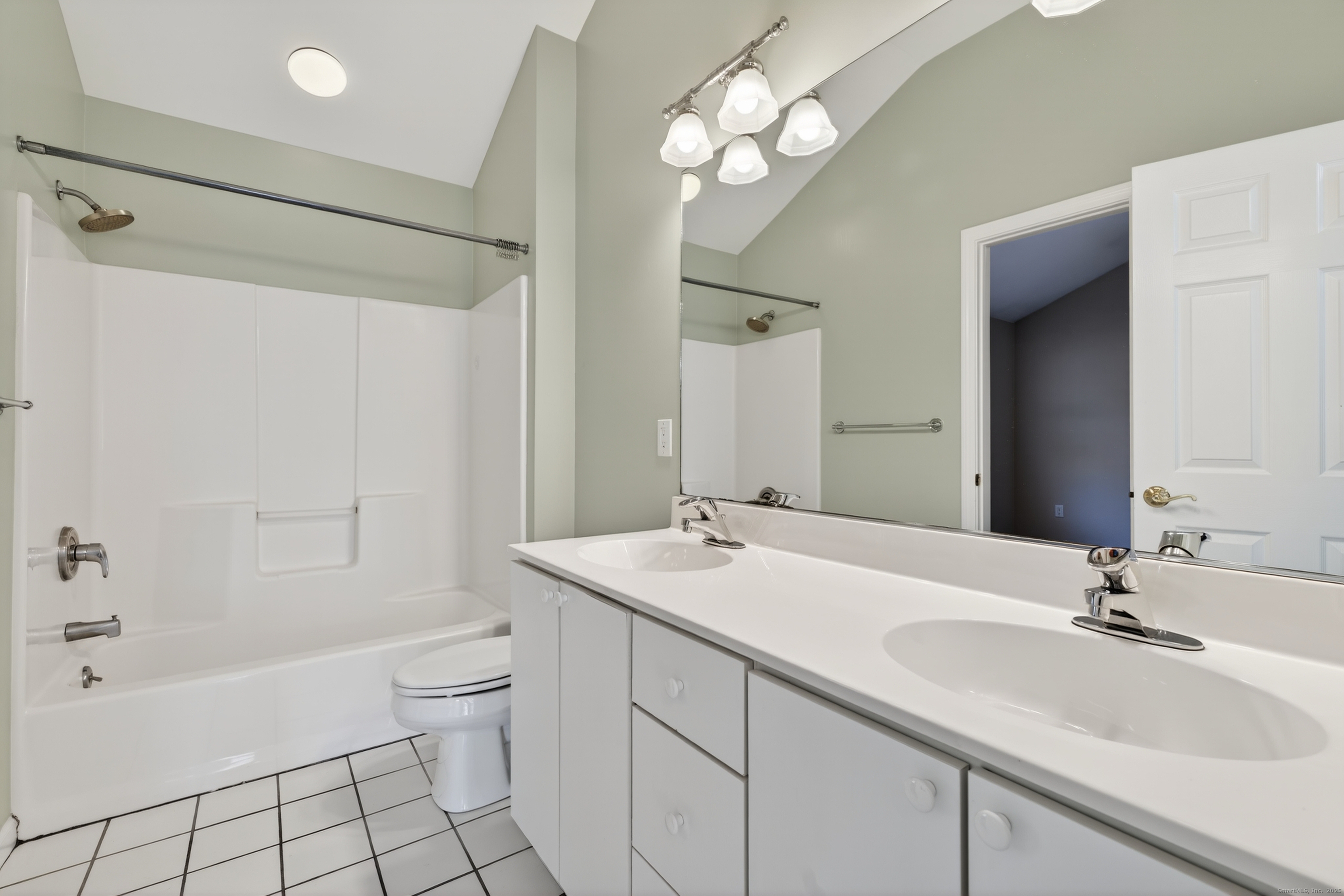 1902 Revere Road, Unit 1902 Danbury, CT 06811 - Photo 17 of 37 a bathroom with a sink a toilet a mirror a bathtub and shower