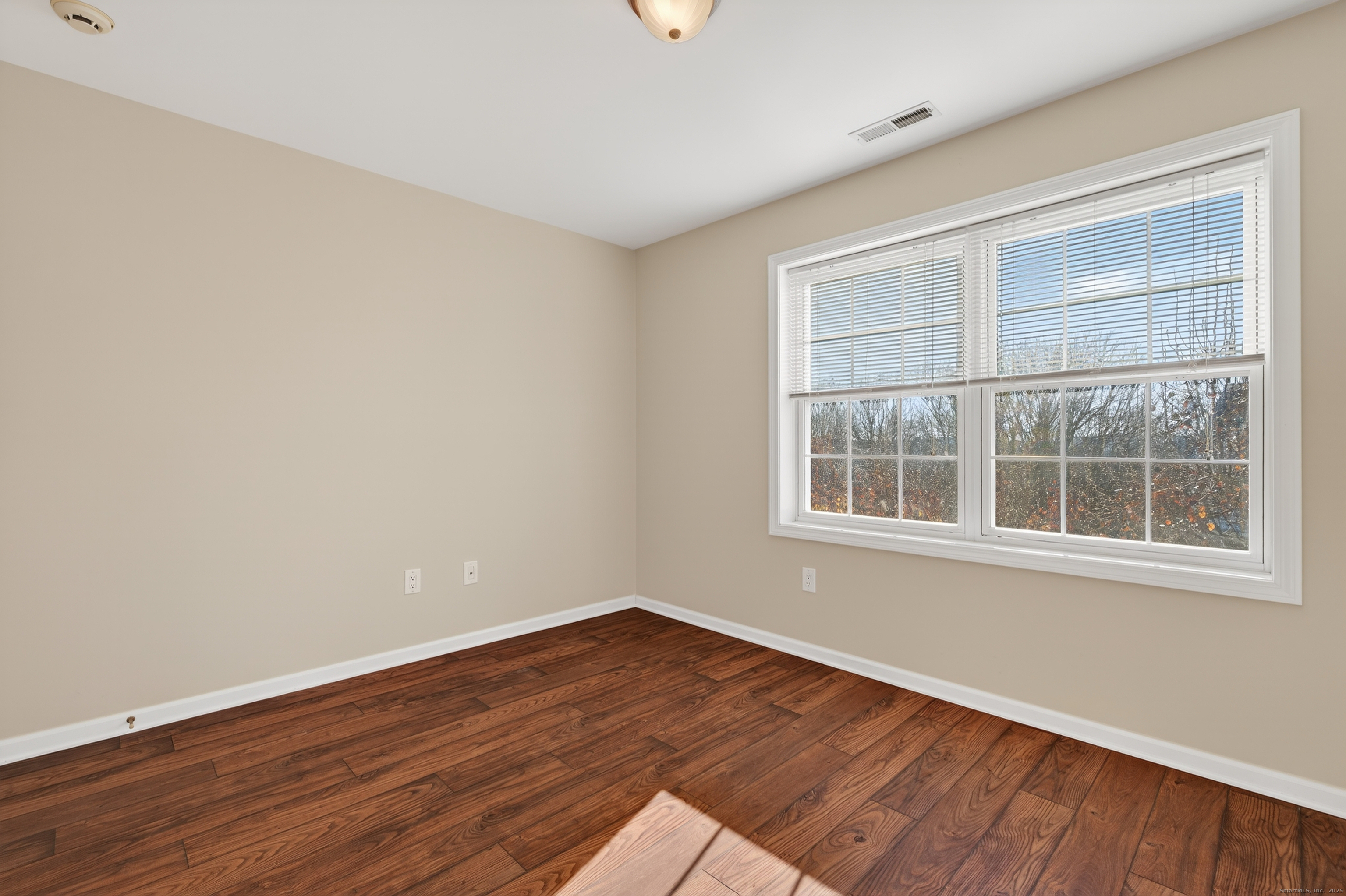 1902 Revere Road, Unit 1902 Danbury, CT 06811 - Photo 18 of 37 a view of an empty room with wooden floor and a window