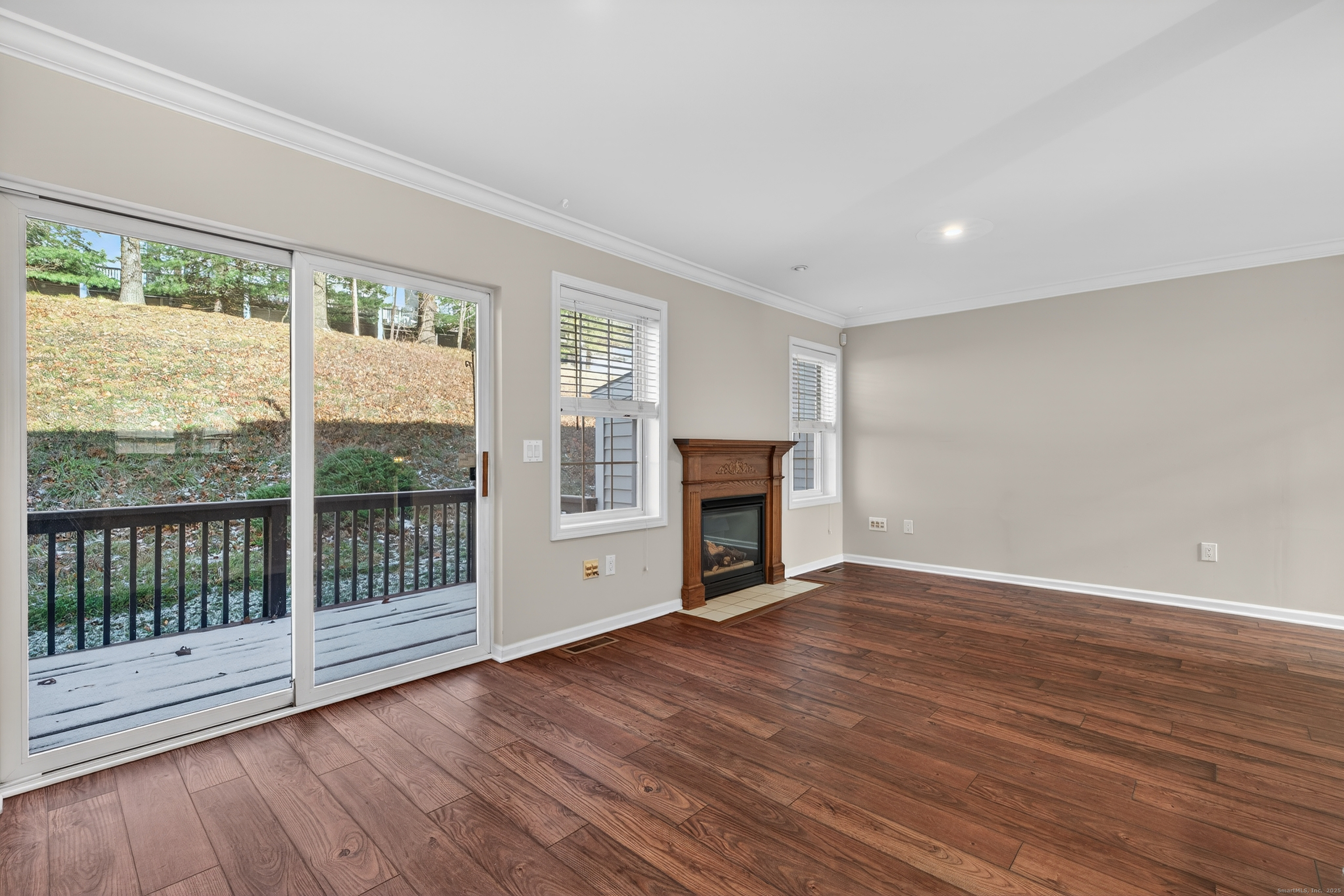 1902 Revere Road, Unit 1902 Danbury, CT 06811 - Photo 4 of 37 a view of empty room with wooden floor and fireplace