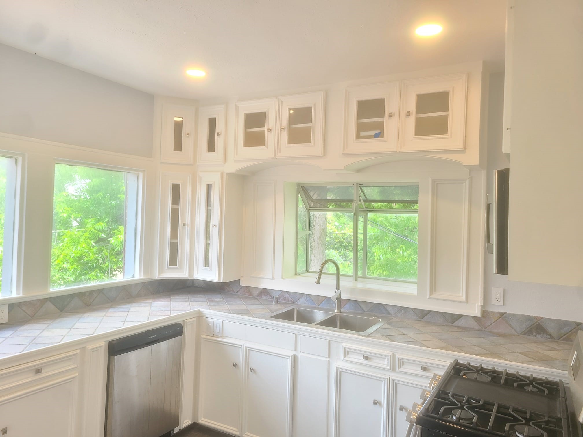 4703 Chenevert Street, Unit 2 Houston, TX 77004 - Photo 16 of 22 a kitchen with granite countertop a sink and a window