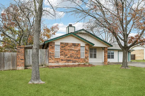 a front view of house with a garden