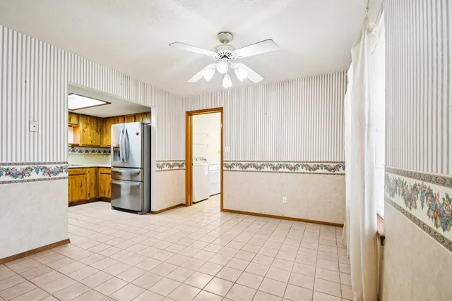 a view of a livingroom with a ceiling fan and window