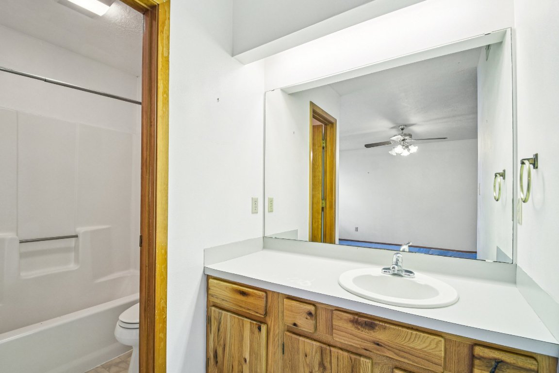 102 Stubblefield Drive Elgin, TX 78621 - Photo 20 of 39 a bathroom with a granite countertop sink and a mirror