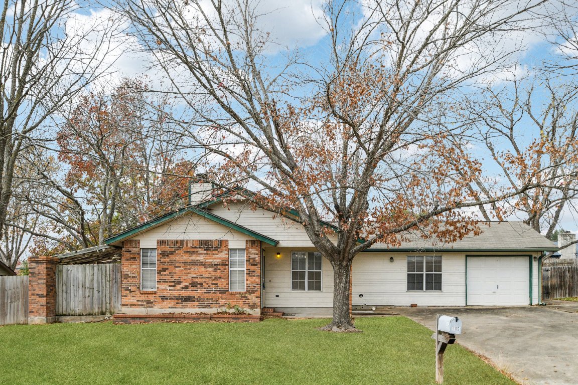 102 Stubblefield Drive Elgin, TX 78621 - Photo 2 of 39 a front view of a house with a garden