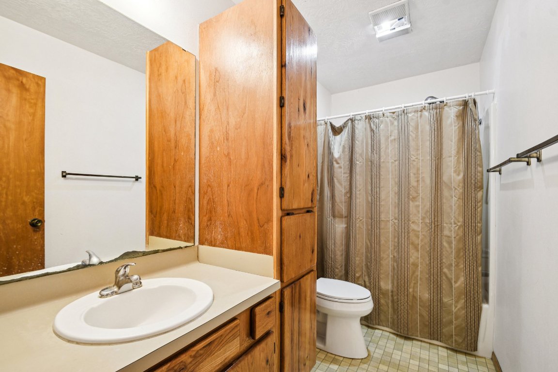 102 Stubblefield Drive Elgin, TX 78621 - Photo 25 of 39 a bathroom with a sink a toilet and shower