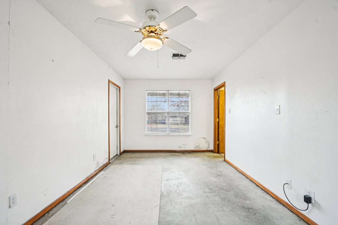 102 Stubblefield Drive Elgin, TX 78621 - Photo 27 of 39 an empty room with windows and chandelier fan