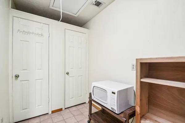 a view of washer and dryer with bathroom in the background
