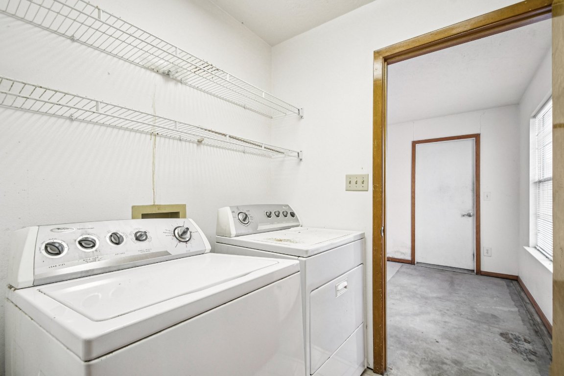 102 Stubblefield Drive Elgin, TX 78621 - Photo 30 of 39 a view of washer and dryer with bathroom in the background