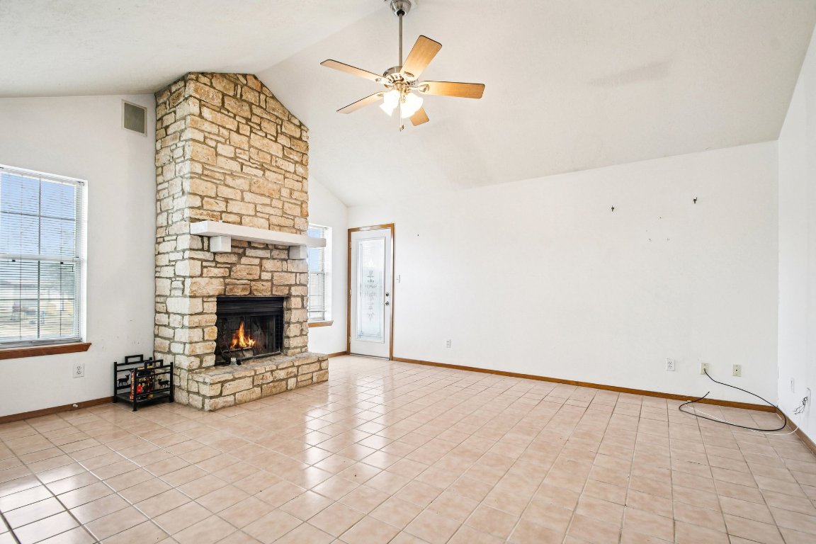 102 Stubblefield Drive Elgin, TX 78621 - Photo 7 of 39 an empty room with windows dryer and fireplace