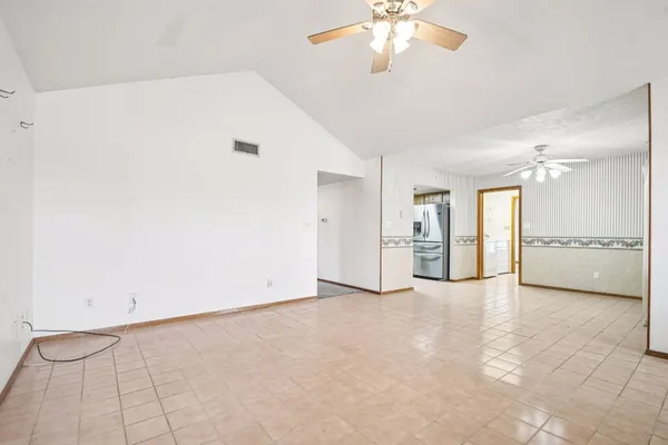 a view of an empty room with a kitchen