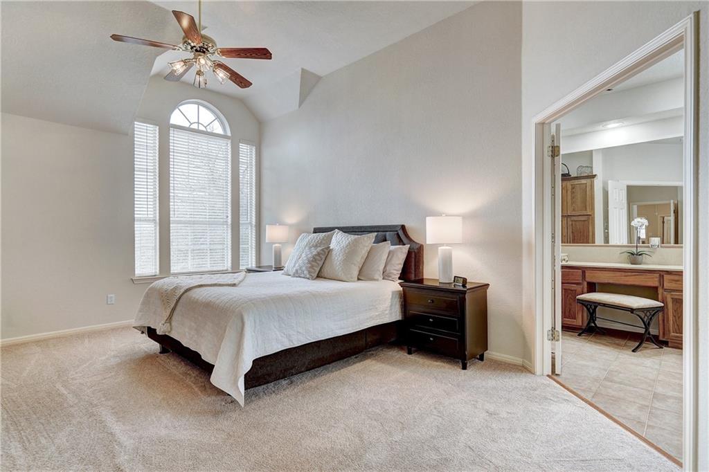 8504 Ephraim Road Austin, TX 78717 - Photo 13 of 16 Bedroom with lofted ceiling, light carpet, a ceiling fan, and ensuite bathroom