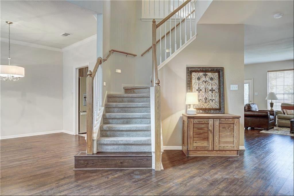 8504 Ephraim Road Austin, TX 78717 - Photo 4 of 16 Stairs featuring wood finished floors, ornamental molding, hanging lights, and a high ceiling