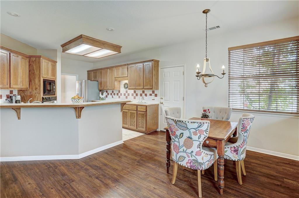 8504 Ephraim Road Austin, TX 78717 - Photo 5 of 16 Dining area with suspended lighting and dark wood-style floors