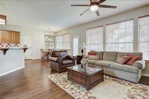 8504 Ephraim Road Austin, TX 78717 - Photo 8 of 16 Living room featuring dark wood-style flooring, ceiling fan, and hanging lights