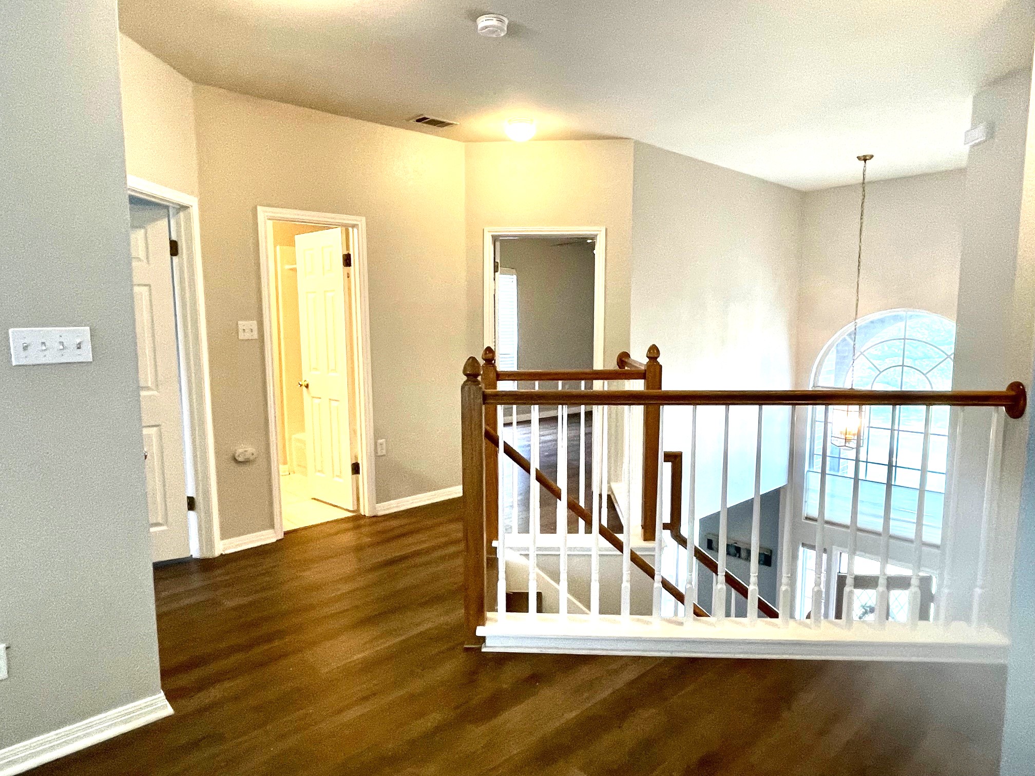 8504 Ephraim Road Austin, TX 78717 - Photo 10 of 16 Corridor with dark wood-style flooring, an upstairs landing, and hanging lights