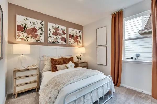 a bedroom with a bed and a painting on the wall