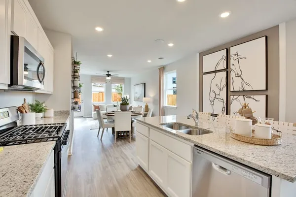 a kitchen with a sink stove and cabinets