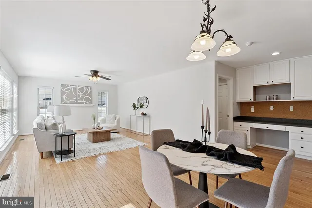 a view of a dining room with furniture wooden floor and chandelier