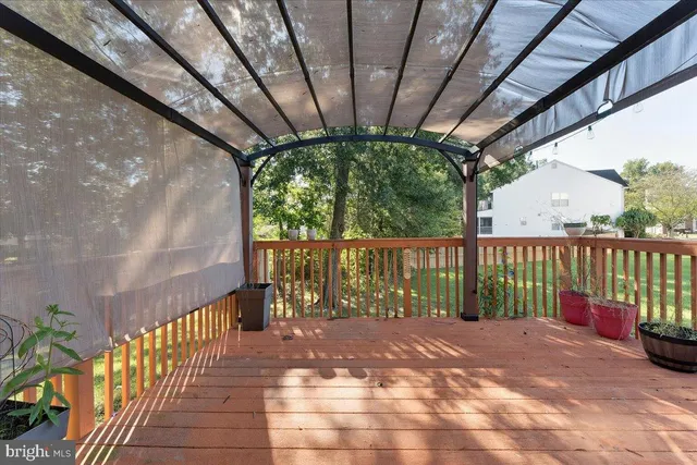 a view of hallway with wooden floor and a chandelier