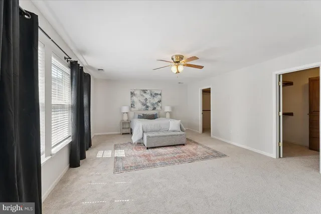 a spacious bedroom with a bed and a couch