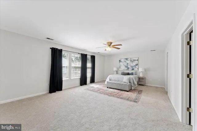 a bathroom with a tub a sink and a large mirror