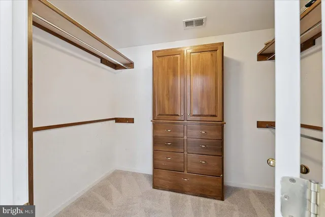 an empty room with a ceiling fan and a window